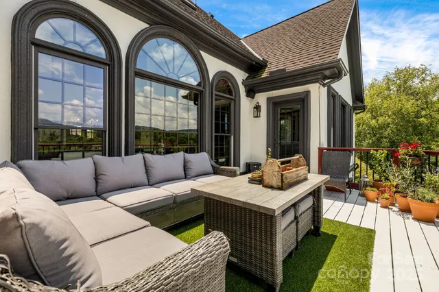 a view of balcony with wooden floor and fence