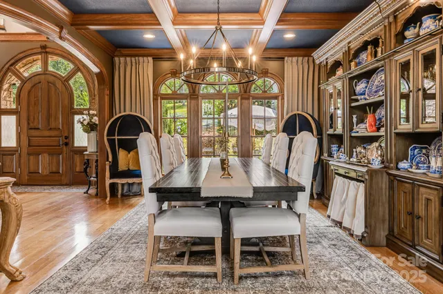 a dining room with furniture a chandelier and fireplace