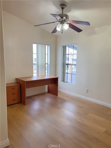 a spacious bedroom with a bed and a chandelier
