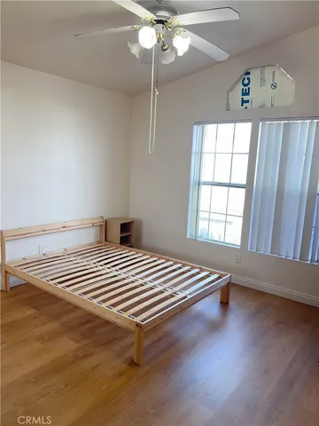 a bathroom with a granite countertop bathtub shower sink vanity and toilet