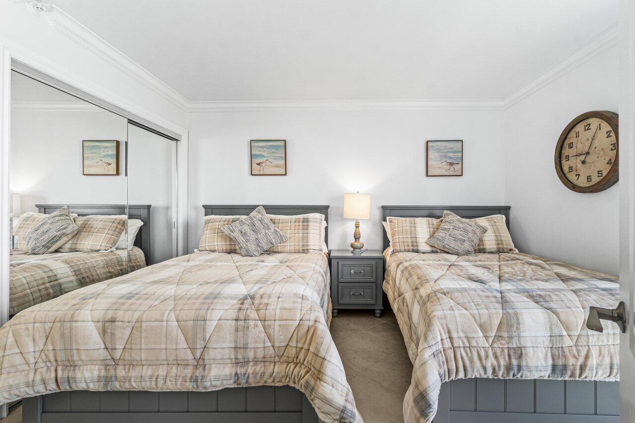 2707 North Ocean Boulevard, Unit 301D Boca Raton, FL 33431 - Photo 15 of 43 a bedroom with double bed and paintings on the wall