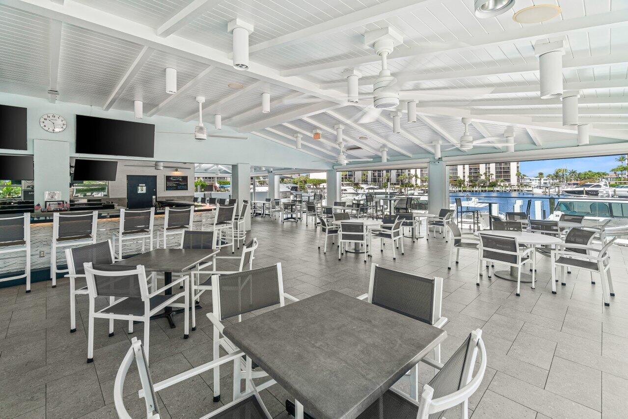 2707 North Ocean Boulevard, Unit 301D Boca Raton, FL 33431 - Photo 31 of 43 a dining room with lots of wooden furniture and a chandelier
