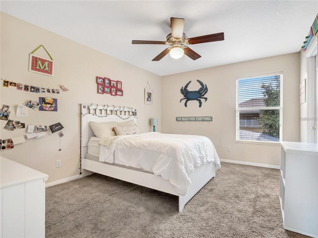 10023 Ians Ridge Road Orlando, FL 32832 - Photo 32 of 60 a bedroom with a bed and a window