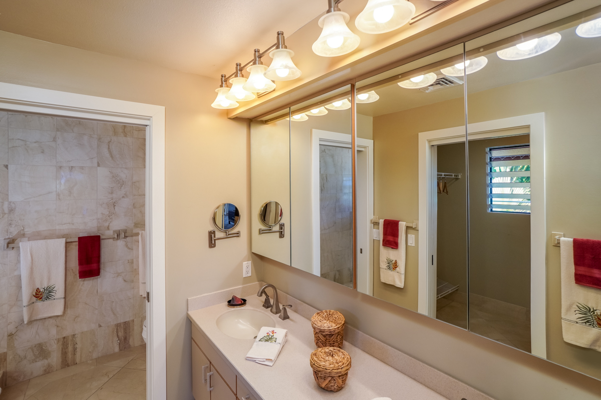 78-6834 Ali‘i Drive, Unit 22B 201 & 202 Kailua-Kona, HI 96740 - Photo 11 of 24 a bathroom with a sink mirror and shower