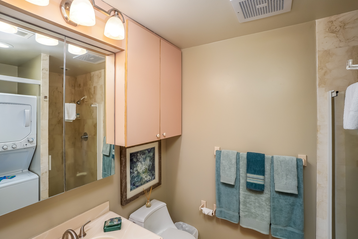 78-6834 Ali‘i Drive, Unit 22B 201 & 202 Kailua-Kona, HI 96740 - Photo 18 of 24 a bathroom with a granite countertop shower a sink and a mirror