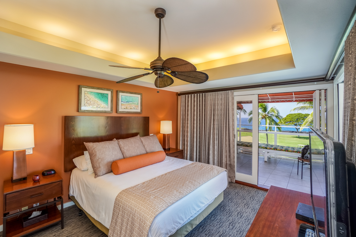 78-6834 Ali‘i Drive, Unit 22B 201 & 202 Kailua-Kona, HI 96740 - Photo 8 of 24 a bedroom with a bed and a chandelier