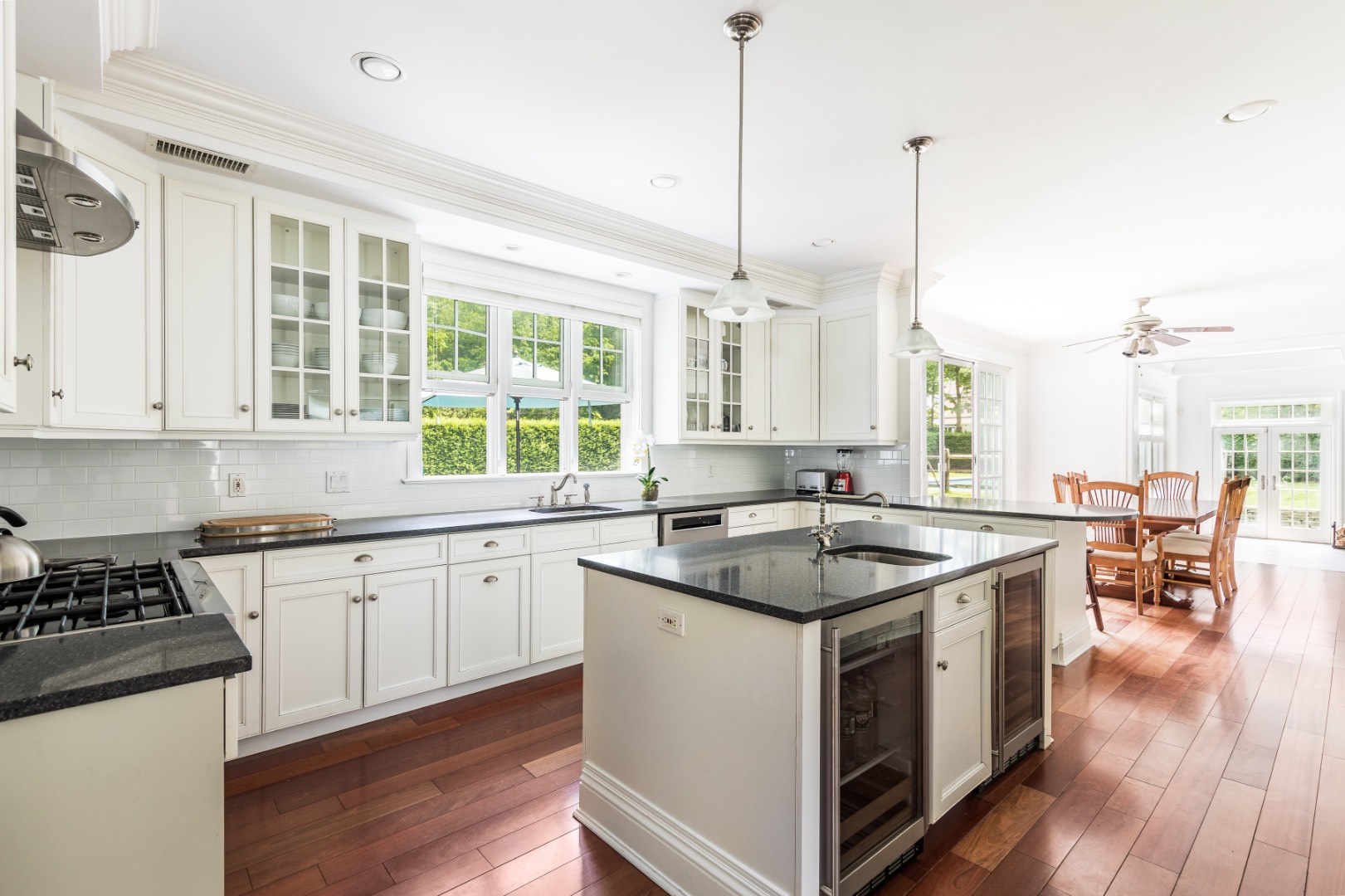 160 Ferry Road Sag Harbor, NY 11963 - Photo 12 of 25 a kitchen with stainless steel appliances granite countertop a stove a sink a center island and a wooden floor