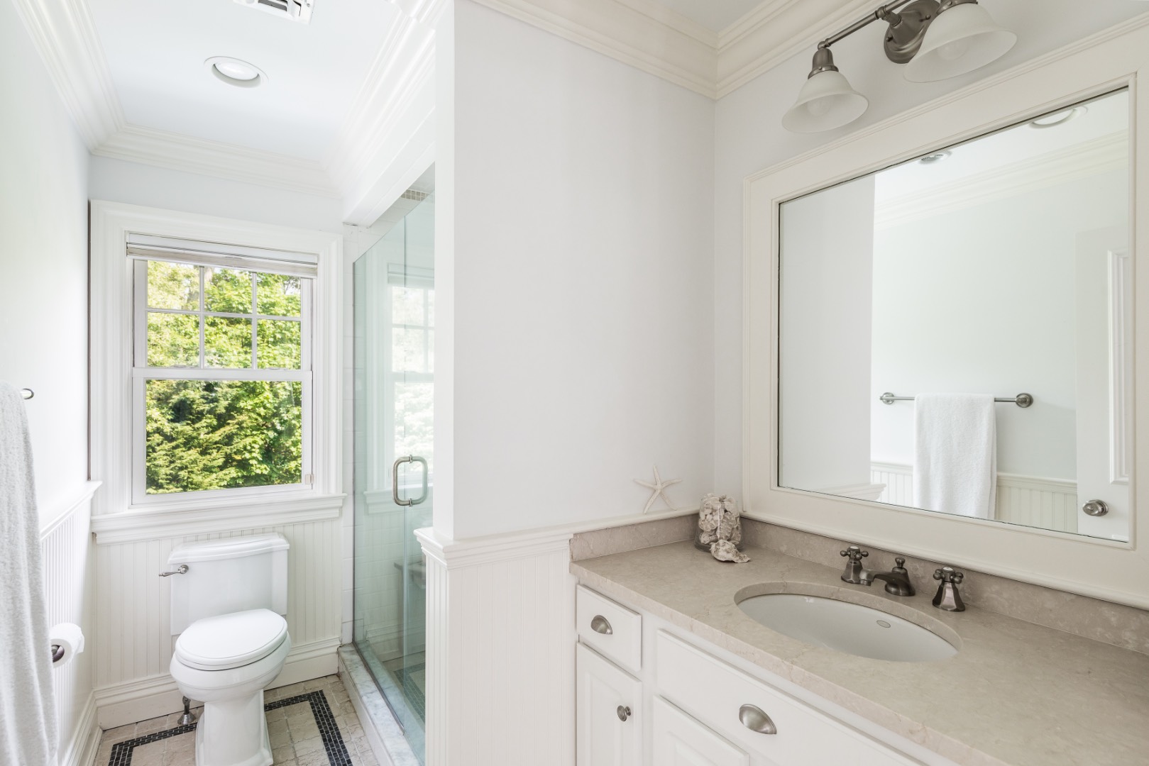 160 Ferry Road Sag Harbor, NY 11963 - Photo 19 of 25 a bathroom with a granite countertop sink toilet and a mirror