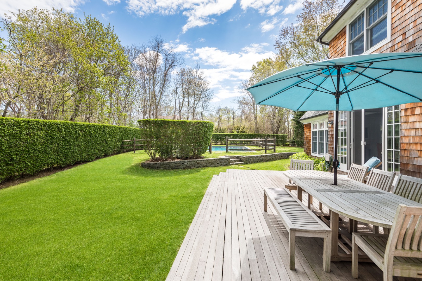 160 Ferry Road Sag Harbor, NY 11963 - Photo 5 of 25 a view of a table and chairs under an umbrella