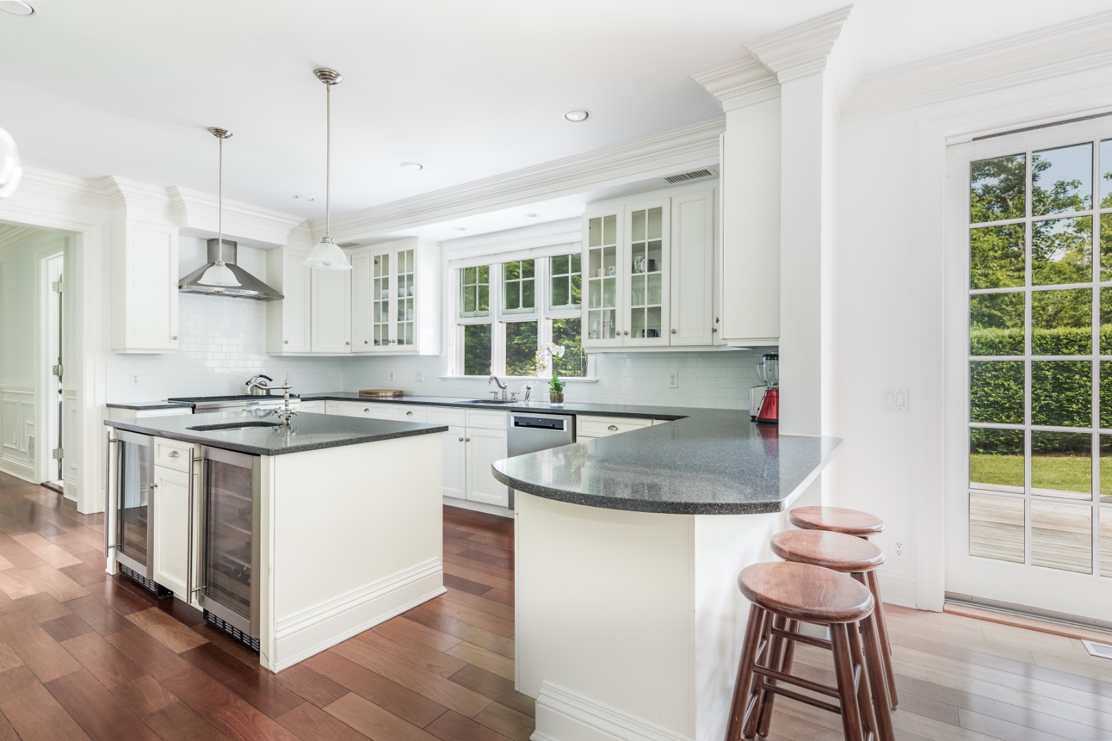160 Ferry Road Sag Harbor, NY 11963 - Photo 10 of 25 a kitchen with stainless steel appliances granite countertop a sink stove and a wooden floor