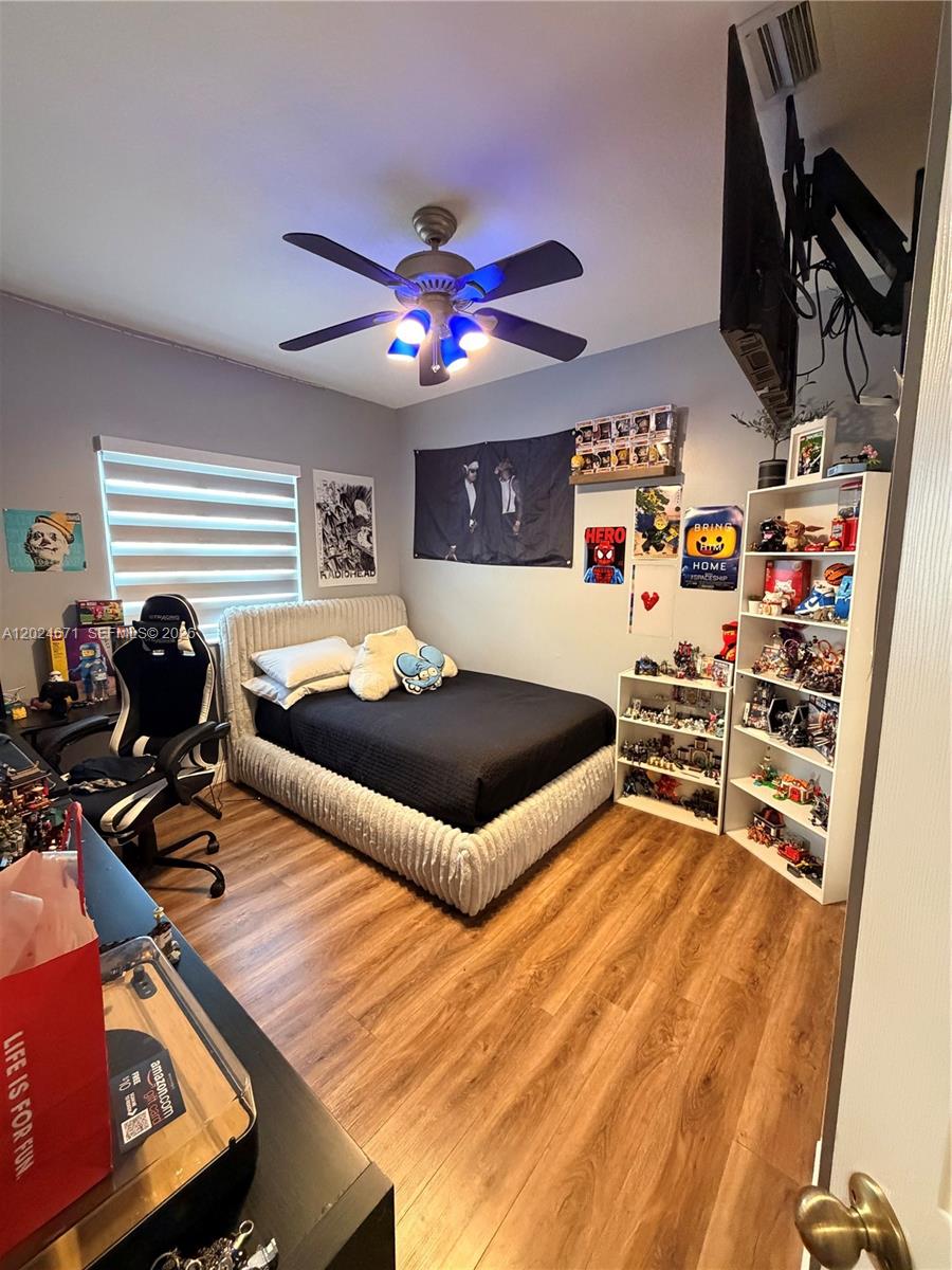 2116 Northeast 38th Road, Unit 2116 Homestead, FL 33033 - Photo 12 of 31 a living room with furniture and a flat screen tv