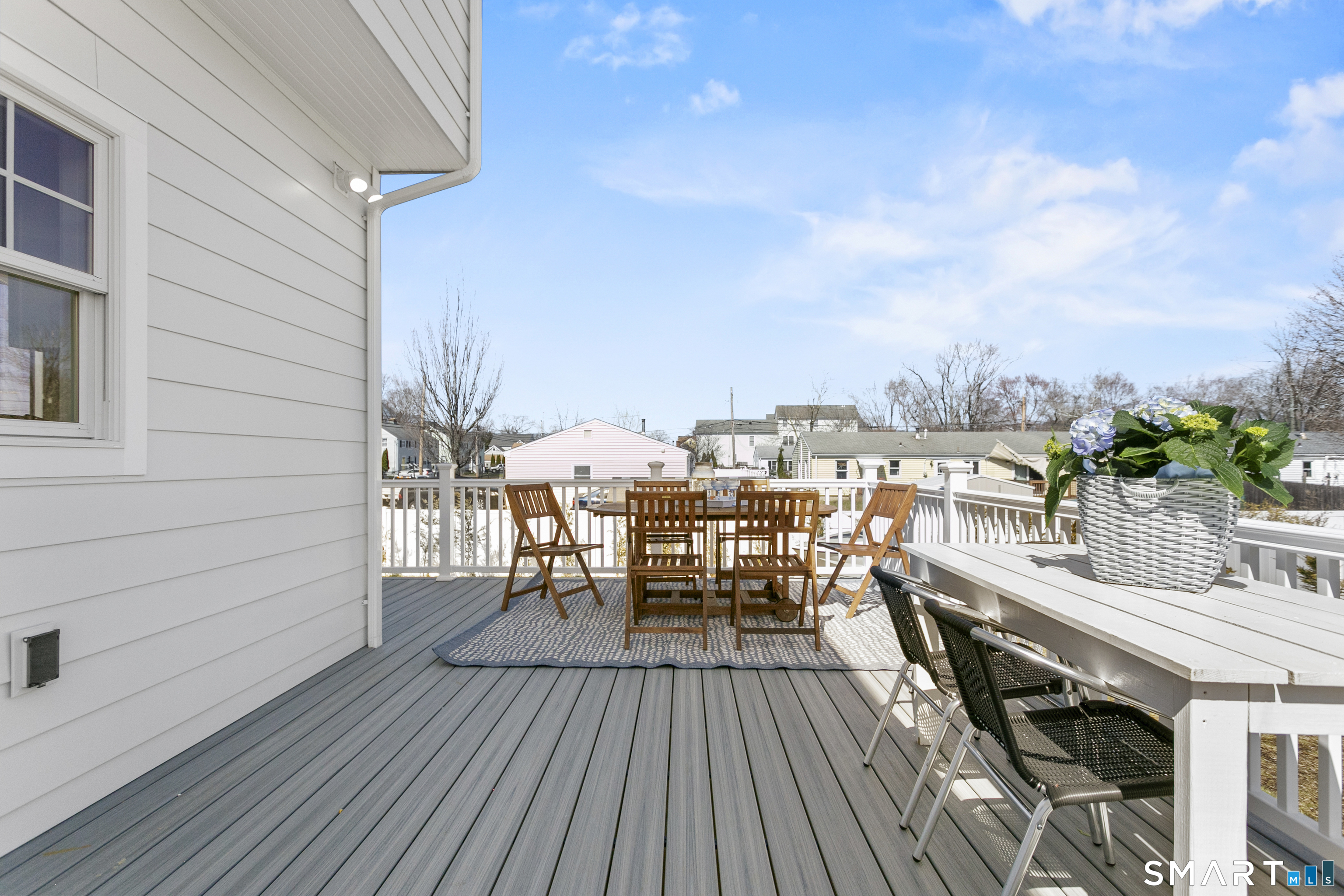12 Sandy Way Fairfield, CT 06824 - Photo 30 of 33 a view of a roof deck with table and chairs a barbeque with wooden floor and fence