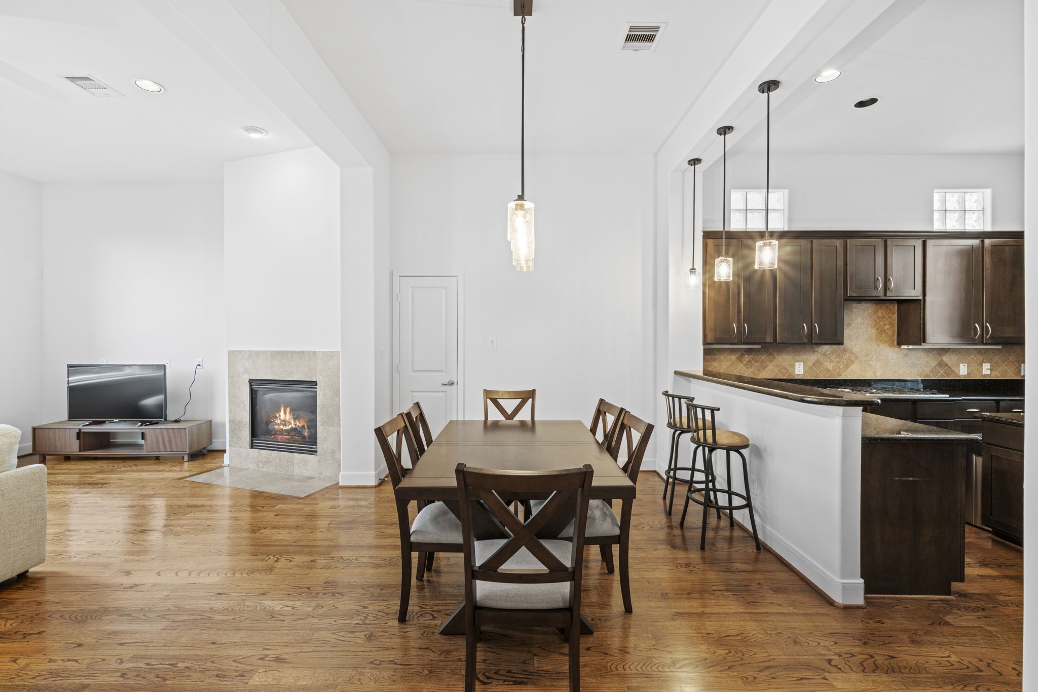 2413 Ralph Street, Unit 9 Houston, TX 77006 - Photo 3 of 19 The kitchen has a seamless flow into the living room, where a gas fireplace creates a warm and inviting focal point.