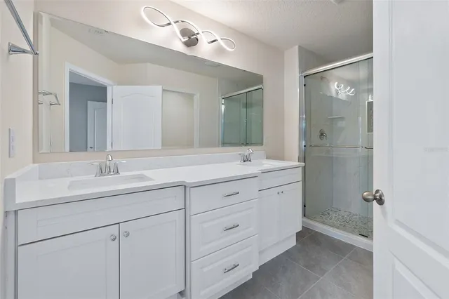 a bathroom with double sink and a mirror