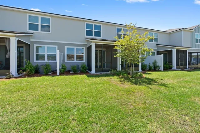 front view of a brick house with a yard