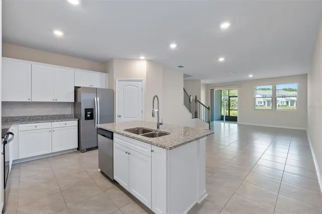 a kitchen with a sink stove and refrigerator