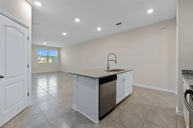 a kitchen with a stove and white cabinets