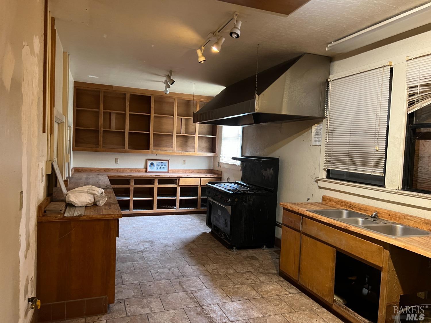 330 South Main Street Willits, CA 95490 - Photo 12 of 16 a kitchen with stainless steel appliances granite countertop a stove and a sink