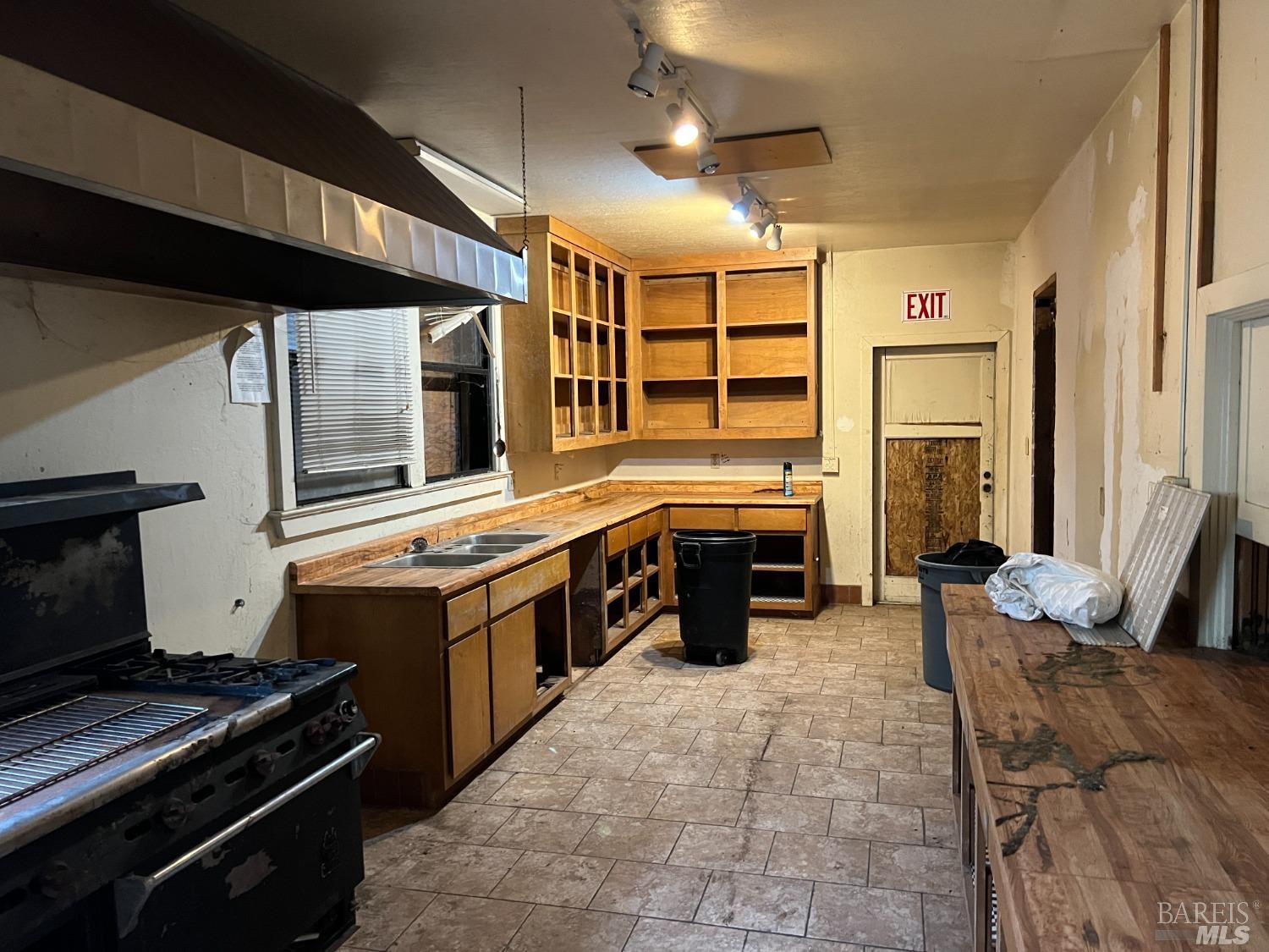 330 South Main Street Willits, CA 95490 - Photo 13 of 16 a kitchen with stainless steel appliances granite countertop a stove and a sink