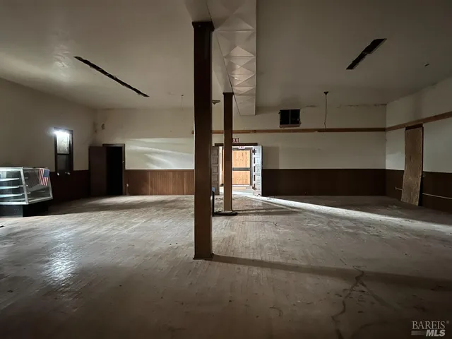 a view of empty room with a fireplace and fan