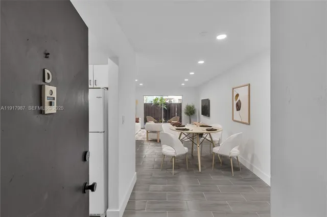 a living room with furniture a rug and white walls