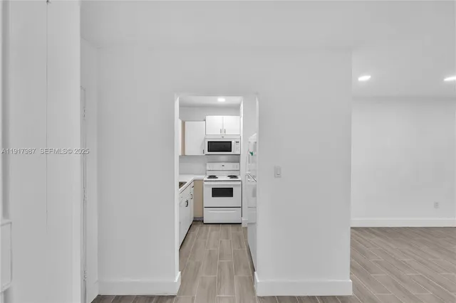 a kitchen with a refrigerator and a stove top oven