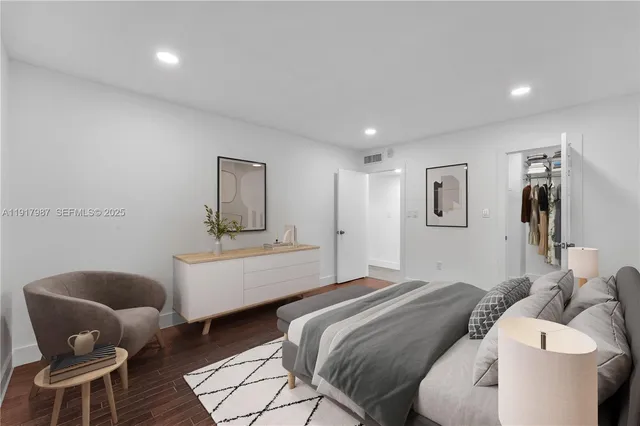 a bedroom with a bed and a chair