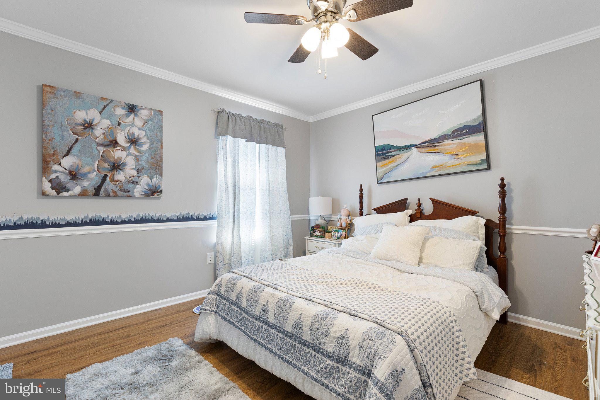 502 Mason Drive New Castle, DE 19720 - Photo 15 of 17 a bedroom with a bed and painting on the wall