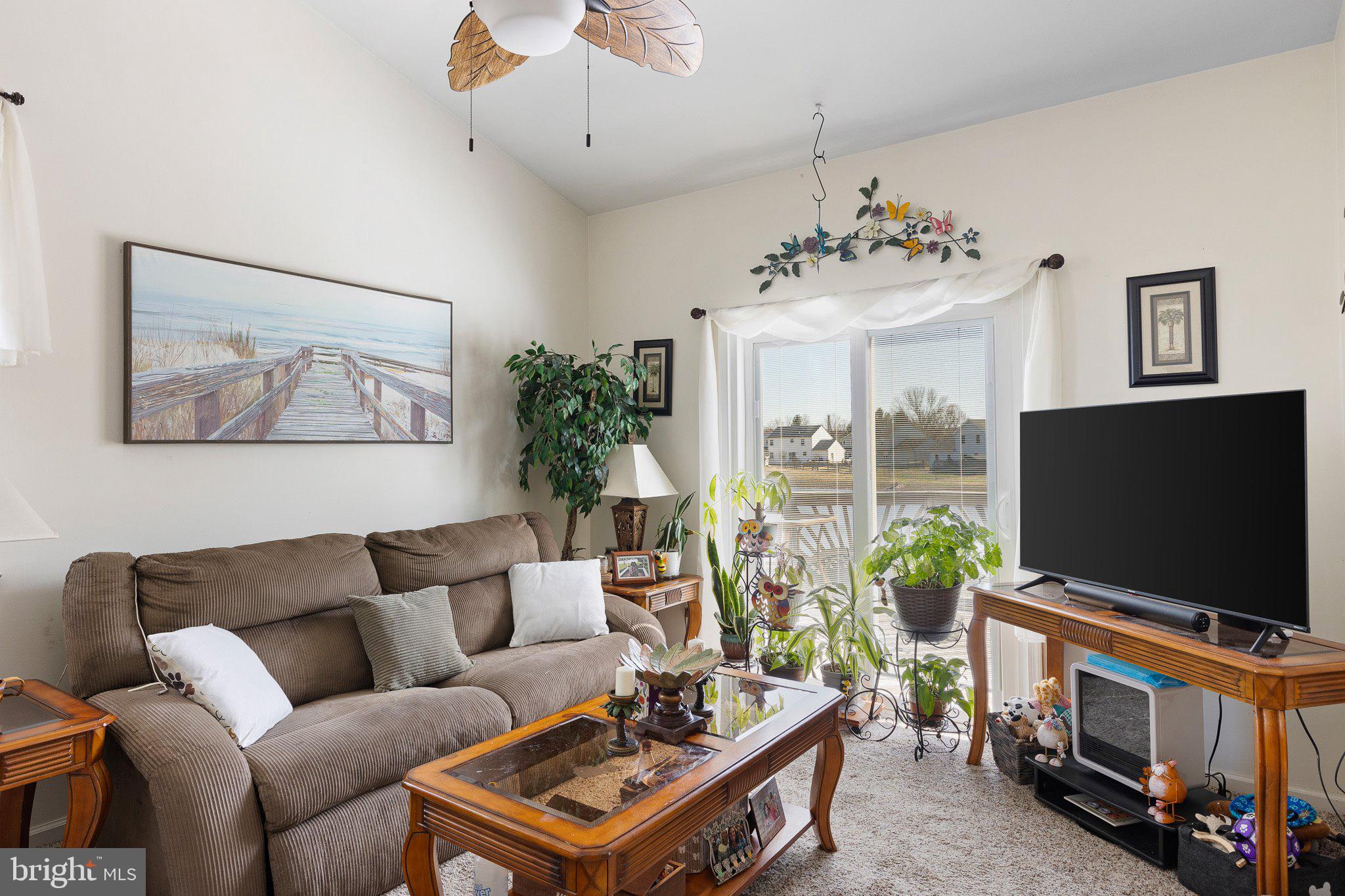 502 Mason Drive New Castle, DE 19720 - Photo 3 of 17 a living room with furniture a flat screen tv and a large window