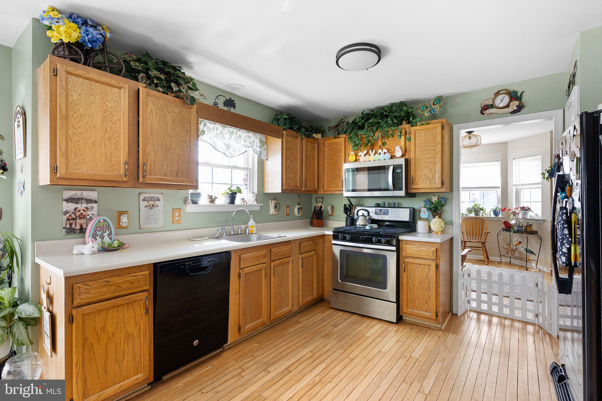 502 Mason Drive New Castle, DE 19720 - Photo 7 of 17 a kitchen with stainless steel appliances granite countertop wooden cabinets a sink dishwasher a stove and a refrigerator with wooden floor