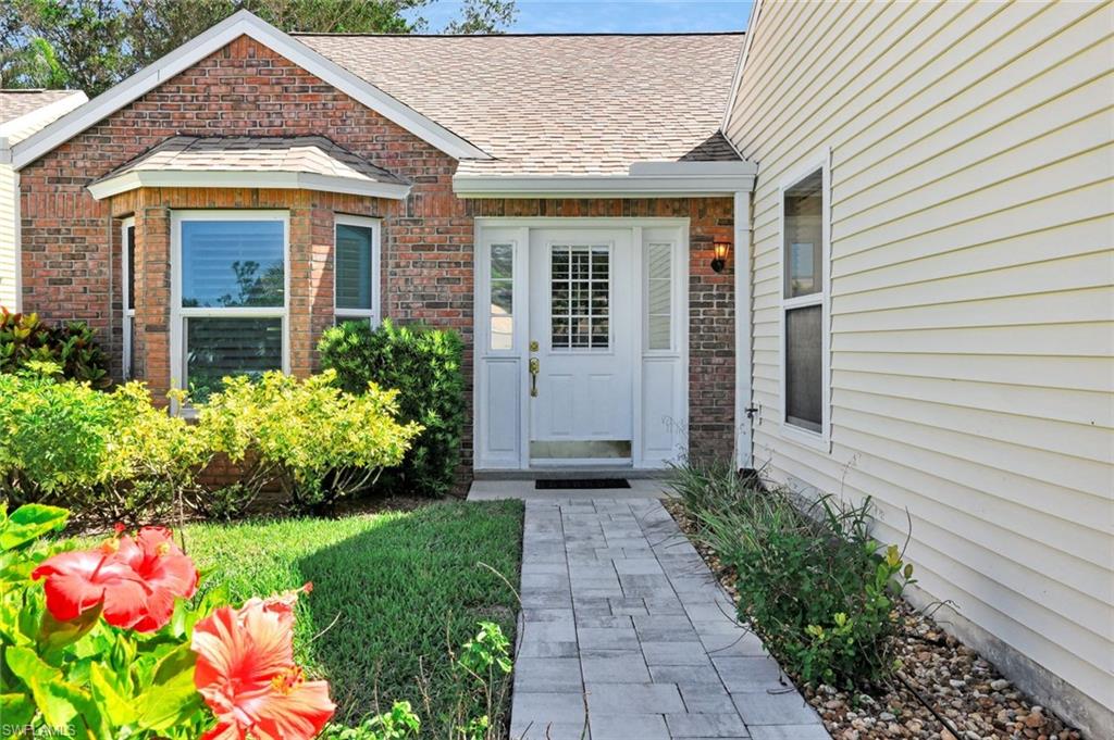 15350 Wimborne Lane, Unit 2 Naples, FL 34110 - Photo 1 of 42 a front view of house with an outdoor space