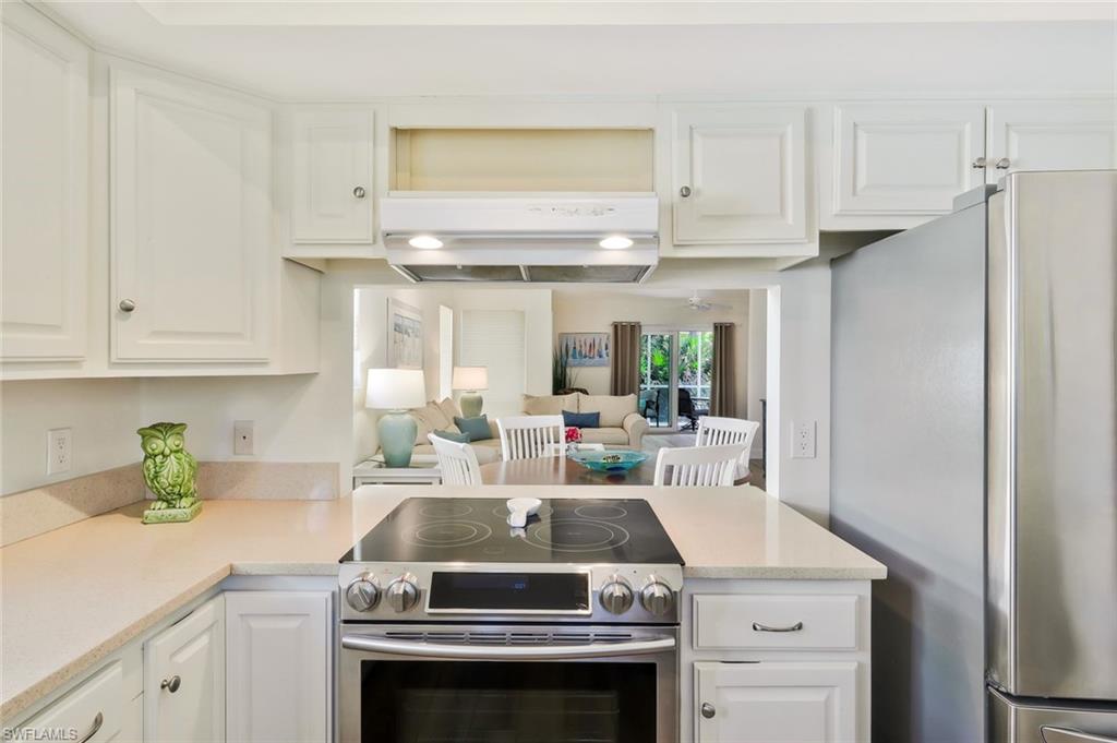 15350 Wimborne Lane, Unit 2 Naples, FL 34110 - Photo 11 of 42 a kitchen with a stove and a refrigerator