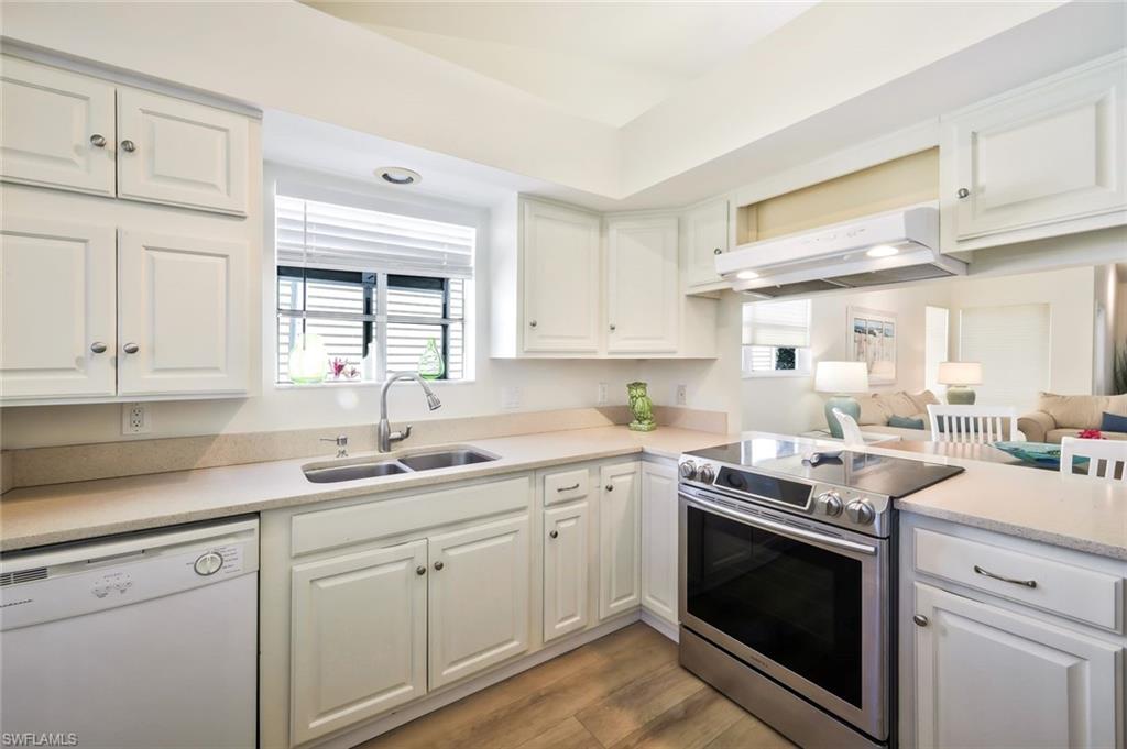 15350 Wimborne Lane, Unit 2 Naples, FL 34110 - Photo 12 of 42 a kitchen with a sink stove and cabinets