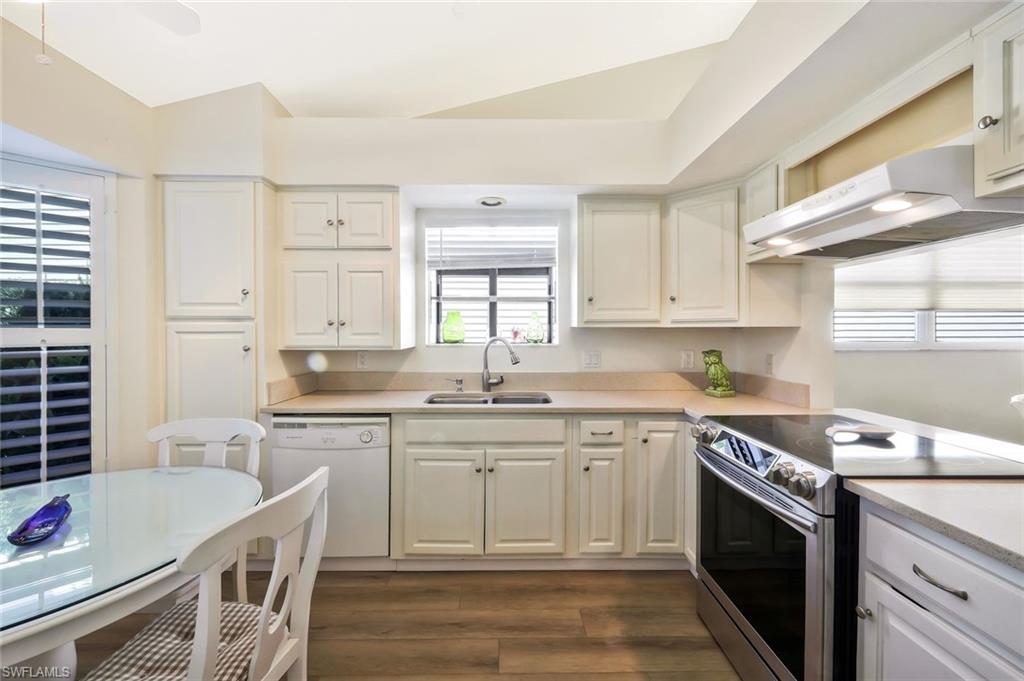 15350 Wimborne Lane, Unit 2 Naples, FL 34110 - Photo 13 of 42 a kitchen that has a sink and a stove in it