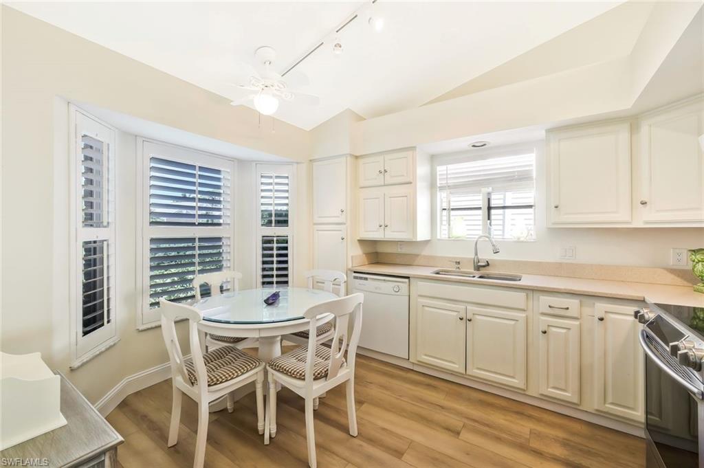15350 Wimborne Lane, Unit 2 Naples, FL 34110 - Photo 14 of 42 a kitchen with a sink and chairs