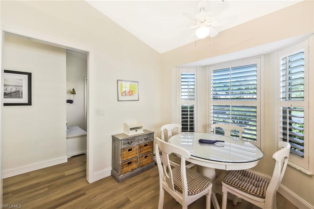 15350 Wimborne Lane, Unit 2 Naples, FL 34110 - Photo 15 of 42 a view of a dining room with furniture and wooden floor