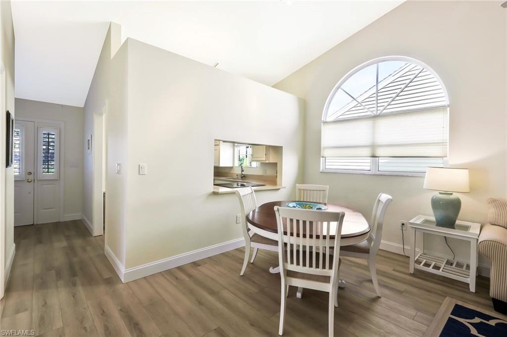 15350 Wimborne Lane, Unit 2 Naples, FL 34110 - Photo 16 of 42 a view of a dining room with furniture window and wooden floor