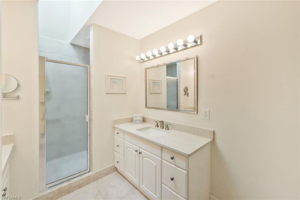15350 Wimborne Lane, Unit 2 Naples, FL 34110 - Photo 21 of 42 a bathroom with a sink and a mirror
