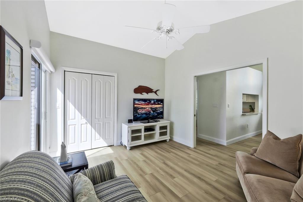 15350 Wimborne Lane, Unit 2 Naples, FL 34110 - Photo 23 of 42 a living room with furniture and wooden floor