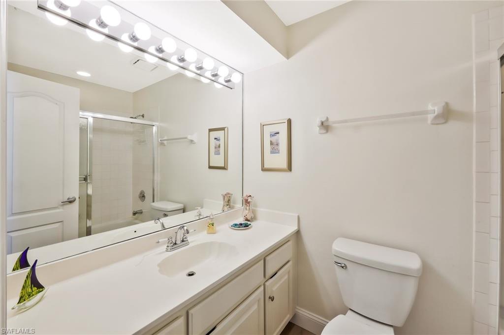 15350 Wimborne Lane, Unit 2 Naples, FL 34110 - Photo 24 of 42 a bathroom with a sink a toilet and shower