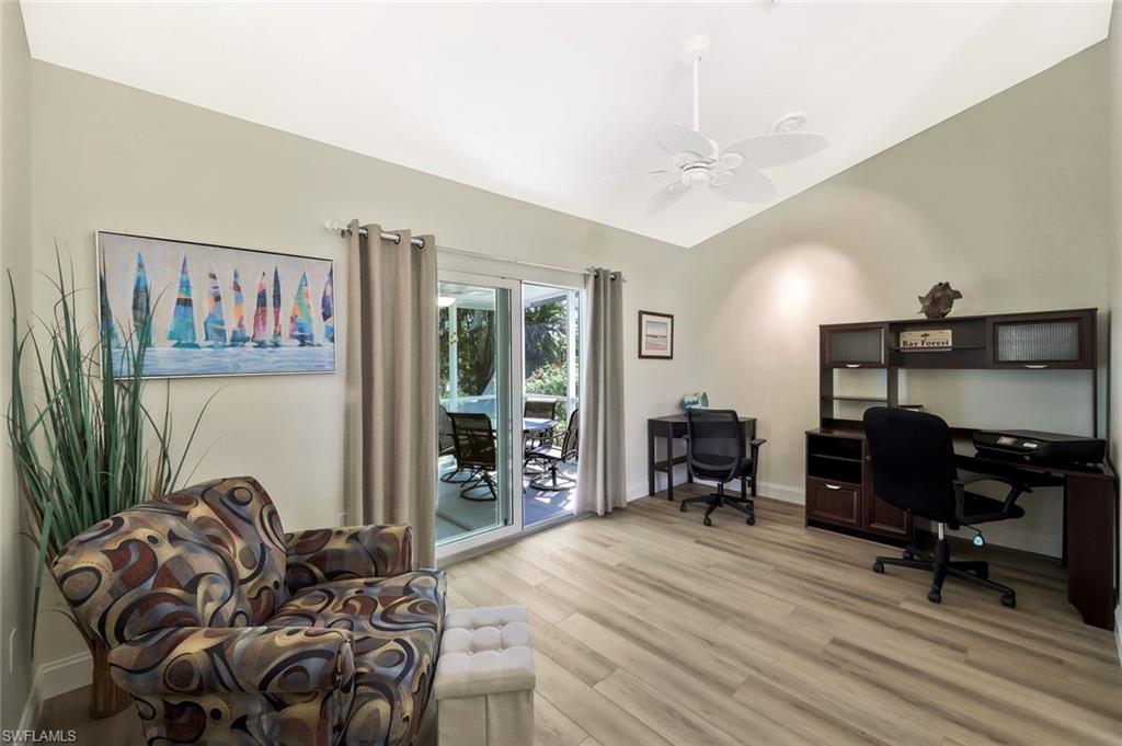 15350 Wimborne Lane, Unit 2 Naples, FL 34110 - Photo 26 of 42 a bedroom with furniture and a wooden floor