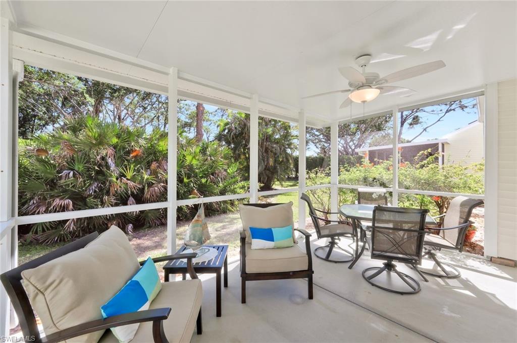 15350 Wimborne Lane, Unit 2 Naples, FL 34110 - Photo 30 of 42 a living room with furniture and a large window