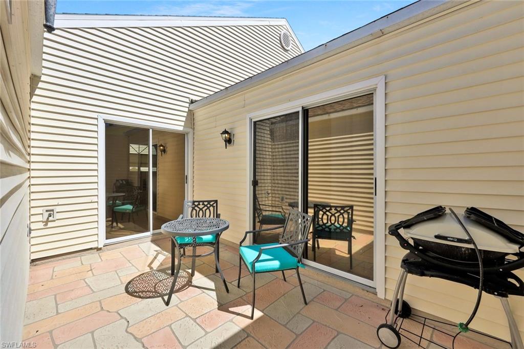 15350 Wimborne Lane, Unit 2 Naples, FL 34110 - Photo 31 of 42 a view of a chairs and table in a balcony