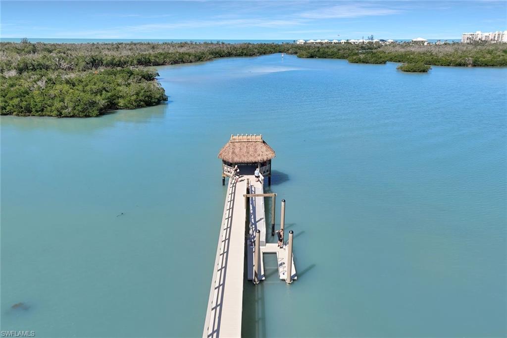 15350 Wimborne Lane, Unit 2 Naples, FL 34110 - Photo 42 of 42 a view of a lake with a mountain in the background