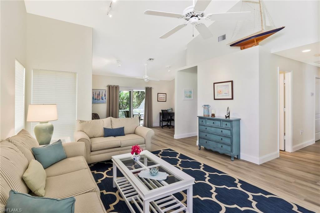 15350 Wimborne Lane, Unit 2 Naples, FL 34110 - Photo 7 of 42 a living room with furniture and a wooden floor