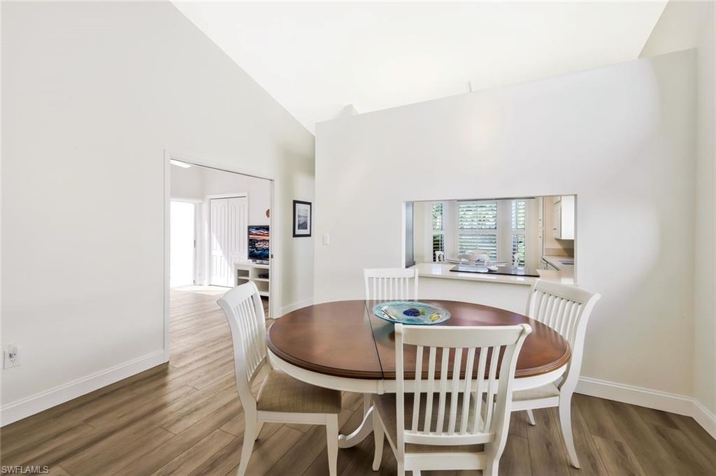 15350 Wimborne Lane, Unit 2 Naples, FL 34110 - Photo 9 of 42 a dining room with furniture and wooden floor