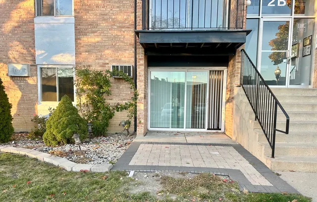 a view of a pathway of a house with a yard