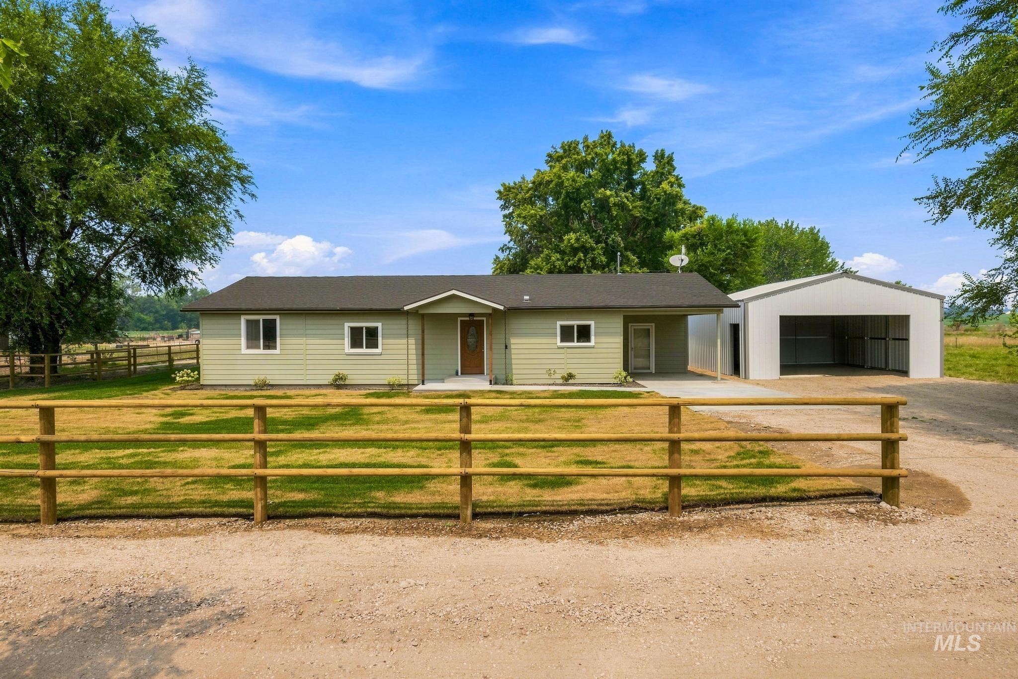 14666 Willis Road Caldwell, ID 83607 - Photo 47 of 50 Ranch-style residence featuring light green siding, a dark roof, and a covered entry