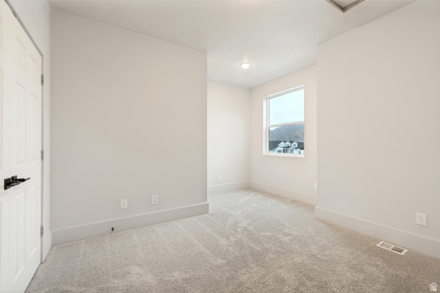 529 North Hvn Drive Mapleton, UT 84664 - Photo 23 of 30 Carpeted room featuring a single window, recessed lighting, and a white paneled door with dark hardware