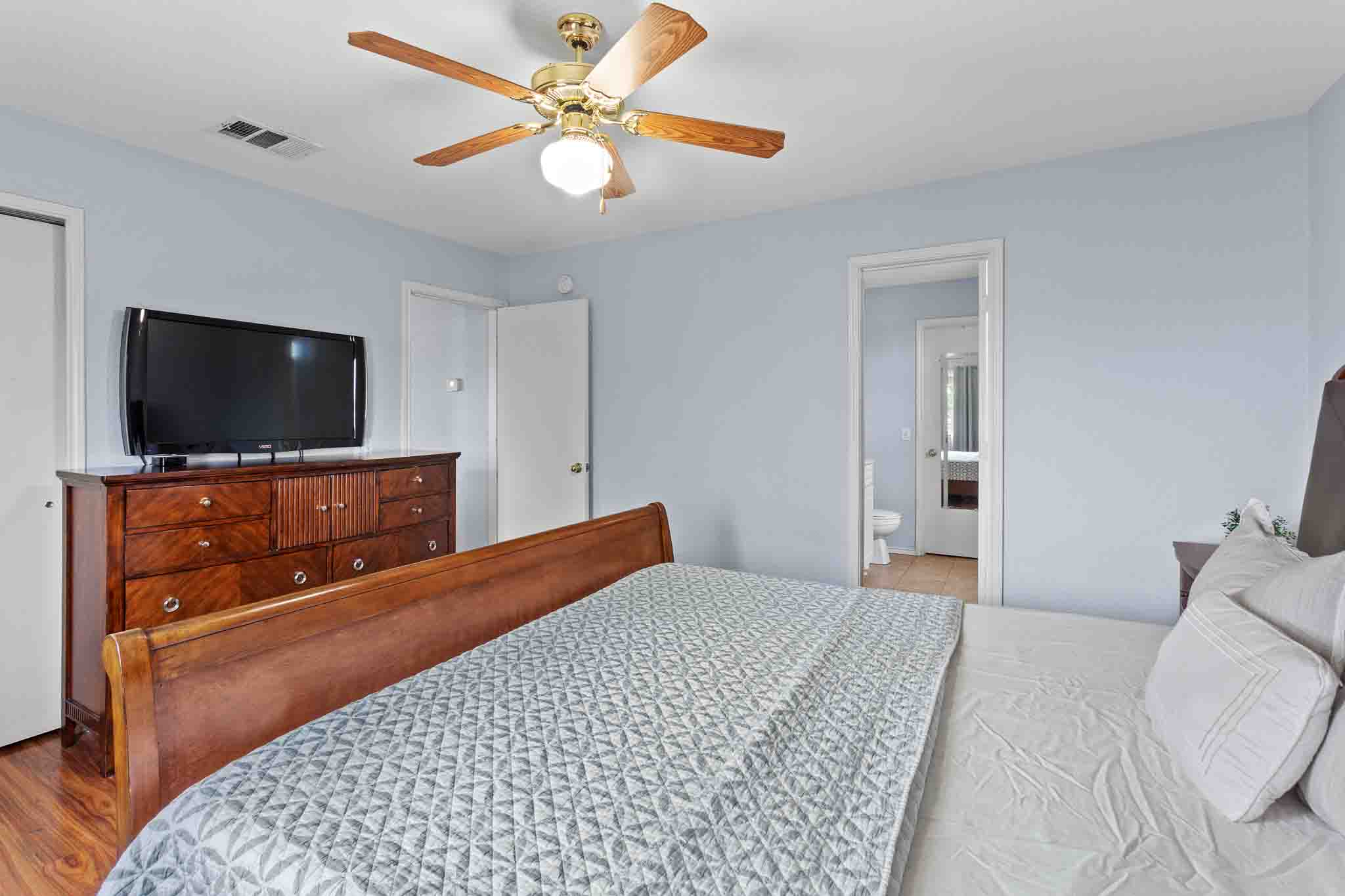 270 Endeavour Kyle, TX 78640 - Photo 11 of 20 This room features a ceiling fan with integrated lighting, light blue walls, and a wooden bed frame
